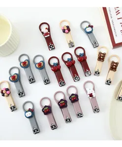 Cute cartoon nail clippers set with various 3d resin charms for kids and daily use.