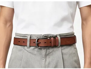 Detailed view of men's vintage brown leather belt worn with casual pants and white t-shirt.