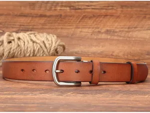 Detail view of vintage genuine leather belt, featuring brown cowhide and metal pin buckle.