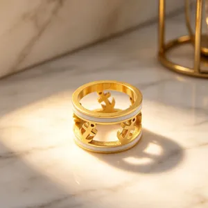 Gold plated hollow anchor ring with white enamel detail, chic geometric fashion jewelry detail.
