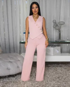 Detailed view of women's pink sleeveless asymmetrical button vest and wide leg pants suit set.