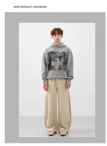 Detailed look at the casual loose wide-leg trousers paired with a stylish grey hoodie.