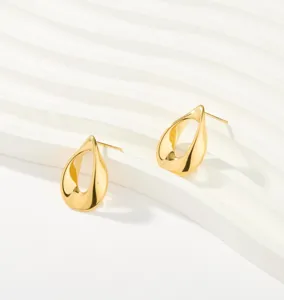 Detailed shot of trendy irregular teardrop stainless steel stud earrings in gold finish.