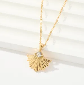 Elegant gold necklace featuring a delicate fan pendant with a sparkling crystal stone.