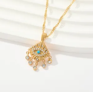 Collar con colgante de mal de ojo dorado con pedrería brillante y cadena retorcida.
