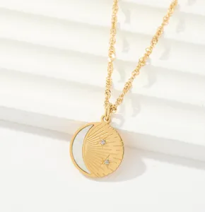 Detailed shot of gold celestial pendant necklace featuring sun, moon, and shimmering stars.