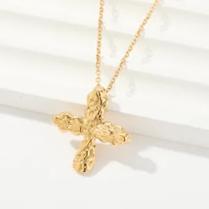 Elegant gold-tone necklace featuring a unique hammered cross pendant, perfect for daily fashion.