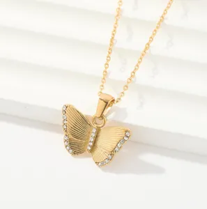Gold butterfly pendant necklace with shimmering crystal stones, elegant and versatile jewelry detail.