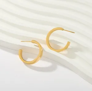 Minimalist gold hoop earrings detail shot, sleek geometric design for women jewelry daily wear.