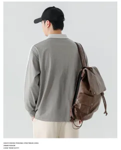 Gedetailleerd overzicht van het heren poloshirt met lange mouwen en contrasterend patchwork.