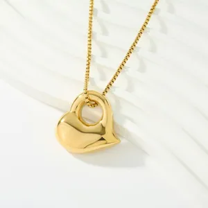 Gold-plated stainless steel hollow heart pendant necklace detail, elegant jewelry design.
