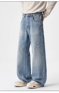 Men's light blue distressed loose fit jeans, vintage wash wide leg denim trousers for casual.