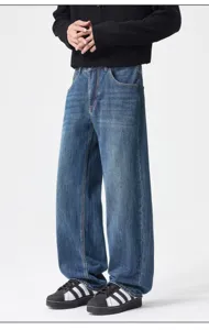 Detail view of vintage blue washed loose wide-leg denim jeans, showing fine fabric and texture.