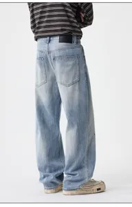 Detail view of men's vintage washed baggy straight denim jeans featuring paint splatter design.