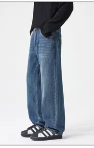 Detailed view of vintage blue washed loose straight leg denim jeans, casual streetwear style.