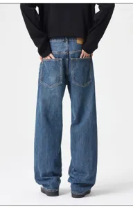 Back view detail of loose fit washed blue straight leg denim jeans with back pockets.