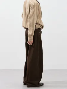 Casual loose wide-leg pants in dark brown paired with a beige striped shirt for daily wear.