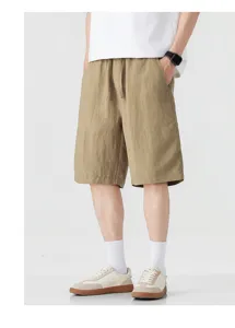 Close-up detail of men's casual khaki shorts with elastic drawstring waist for summer.
