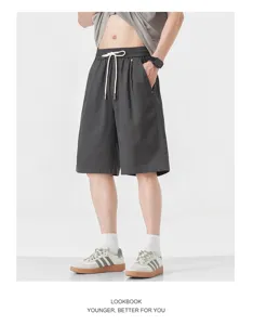 Detail shot of men's casual grey shorts, featuring elastic drawstring waist and relaxed fit.