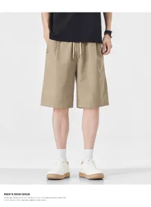 Detail shot of men's casual khaki shorts, loose straight fit with comfortable drawstring waist.