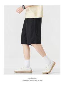Detail view of men casual black shorts, breathable fabric and loose fit for daily summer wear.