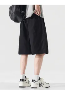 Detail view of men's black casual shorts, loose straight-fit summer trousers with pockets.
