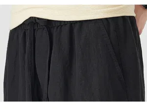 Detail view of black casual shorts waist, elastic drawstring design, breathable summer fabric.