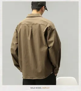 Detailed rear view of men's casual long-sleeve work shirt, showcasing loose fit and vintage style.