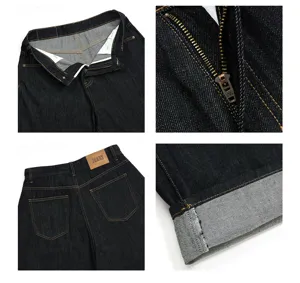 Men's black raw denim jeans detail close-up, YKK zipper, classic back pocket leather patch.