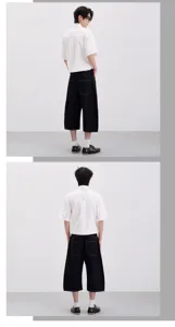 Men's cleanfit short sleeve white shirt and dark wide leg cropped raw denim jeans detail.