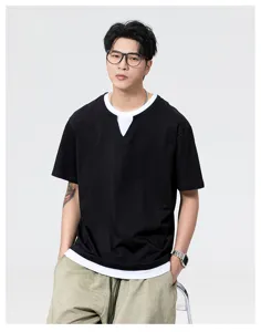 Detail view of the black fake-two-piece short sleeve T-shirt worn by male model.