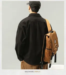 Close-up detail shot of men's casual long sleeve workwear shirt styled with a stylish backpack.