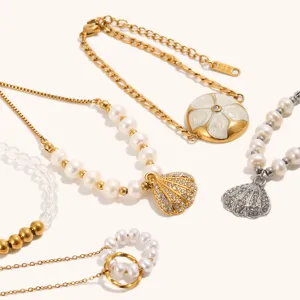 Close-up detail of trendy ocean vacation style stainless steel pearl shell necklaces.