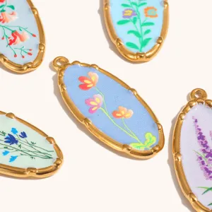 Detailed view of oval gold-plated floral pendant charms, DIY jewelry making accessories.