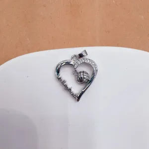 Heart-shaped volleyball pendant with cubic zirconia inlay, stylish sports jewelry item.