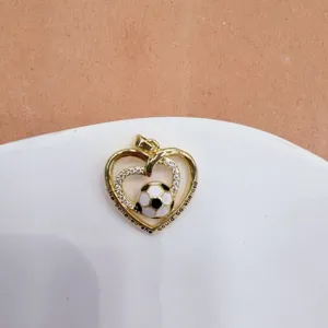 Gold-plated heart soccer pendant with cubic zirconia inlay and inspirational text detail.