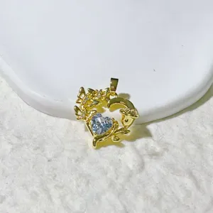 Detailed close-up of a gold plated heart zircon pendant featuring delicate butterfly motifs.