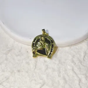 Detailed close-up of a brass micro-inlaid zircon horseshoe horse head pendant accessory.