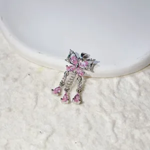 Detailed close-up of a sparkling pink zircon butterfly tassel pendant for DIY jewelry.