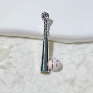 Close-up detail of the silver-tone baseball bat and pink baseball pendant charm for DIY jewelry.