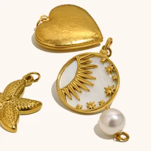 Close-up details of gold-plated stainless steel heart locket, sun star pendant and starfish.