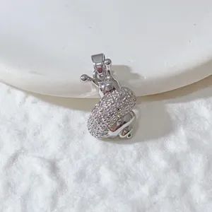 Close-up detail of the sparkling rhinestone animal pendant charm, delicate accessories.