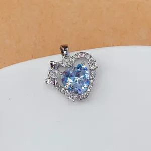 Detail shot of sparkly heart zircon pendant with bow accessory, perfect for DIY jewelry making.