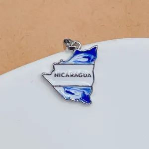 Close-up detail of Nicaragua map metal pendant, exquisite gold plated enamel charm accessory.