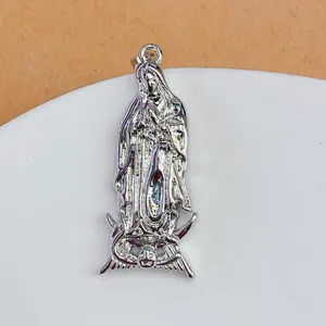 Close-up detail of silver religious idol pendant with exquisite metal carving craftsmanship.