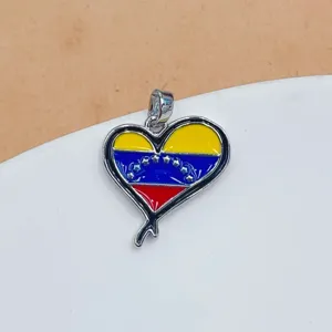 Detailed close-up shot of a Venezuela flag heart pendant made of gold-plated copper.