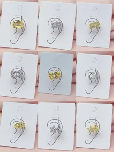 Detailed view of fashionable metal ear cuffs, exquisite zircon geometric design accessories.