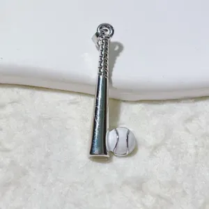 Close-up detail of silver baseball bat and ball pendant jewelry accessory pendant piece.