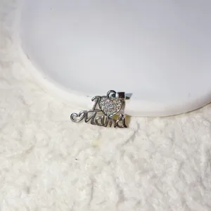 Detailed view of copper gold-plated micro paved zircon Mama heart pendant accessory.