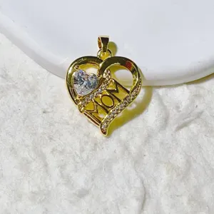 Exquisite heart-shaped pendant detail featuring sparkling micro-set zirconia and MOM text.
